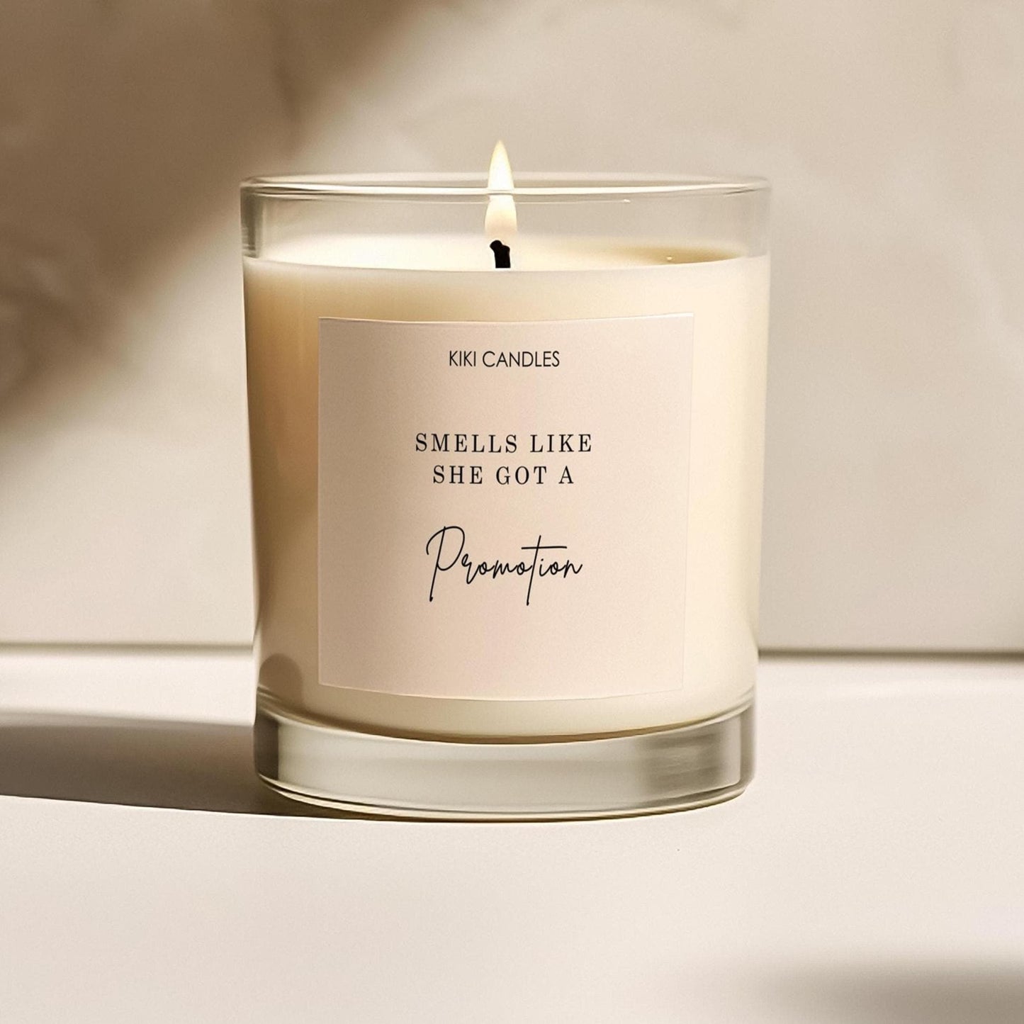 “Smells Like She Got a Promotion” soy candle – handmade UK gift for promotion or new job, minimalist label.